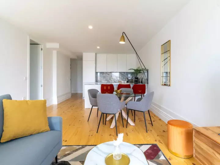Open plan living area in The Sunset Apartment featuring modern dining room table and chairs