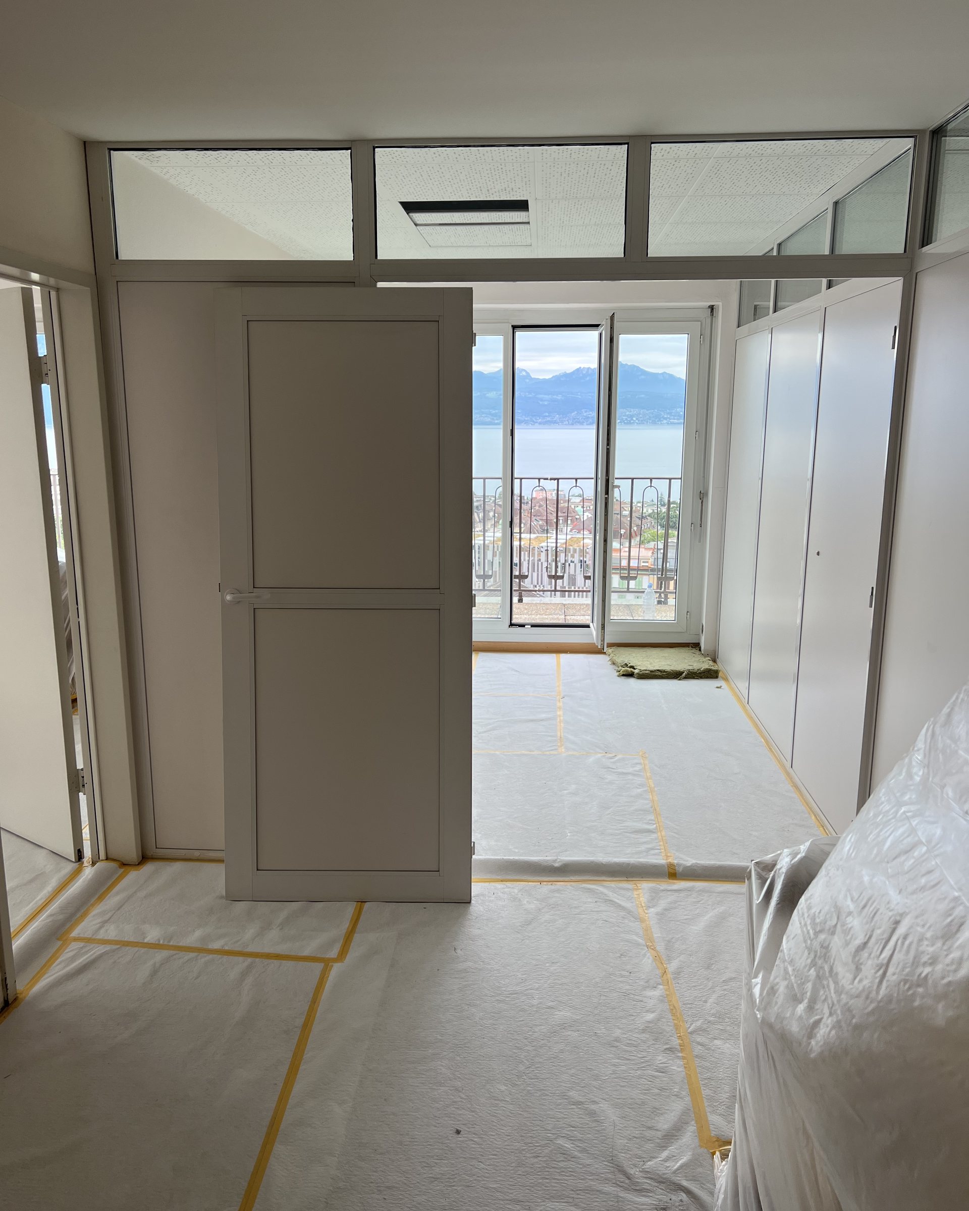 Glazed partition and door with the lake visible beyond