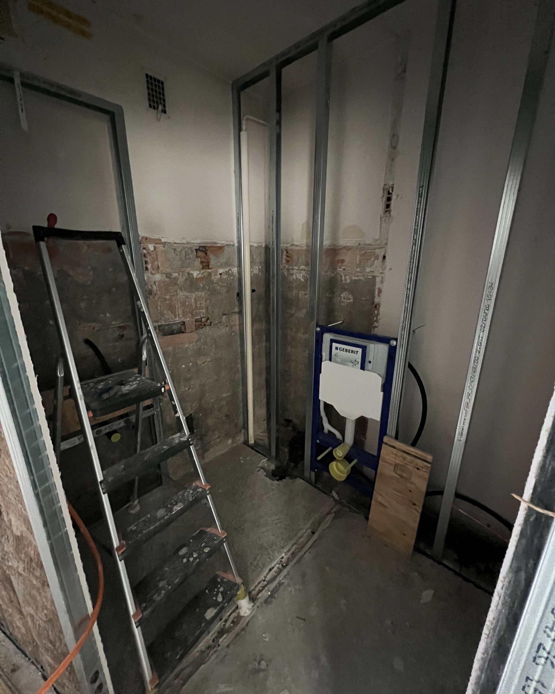 Bare stud walls and exposed plumbing