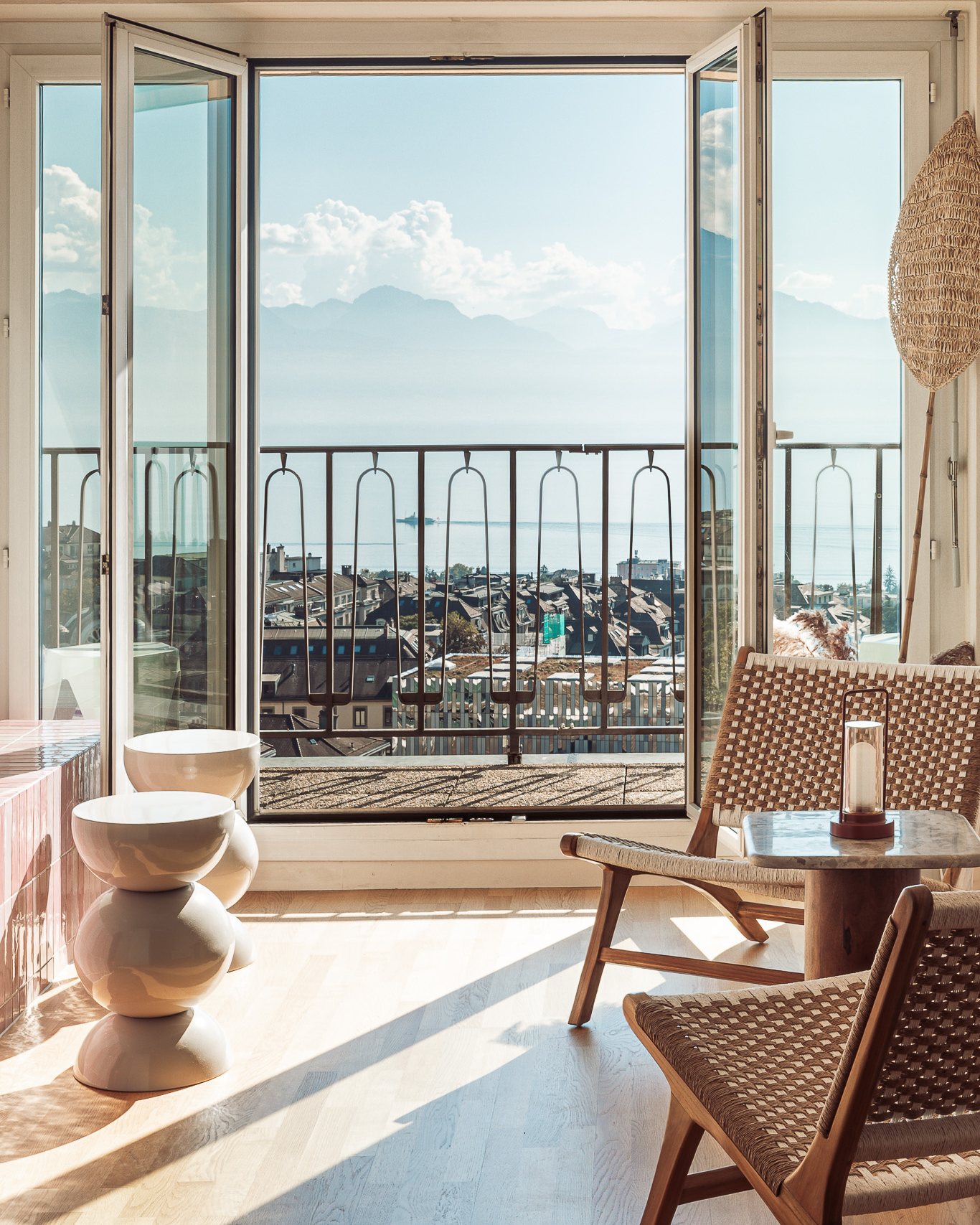Lounge with open balcony doors and a view over Lausanne to the Alps