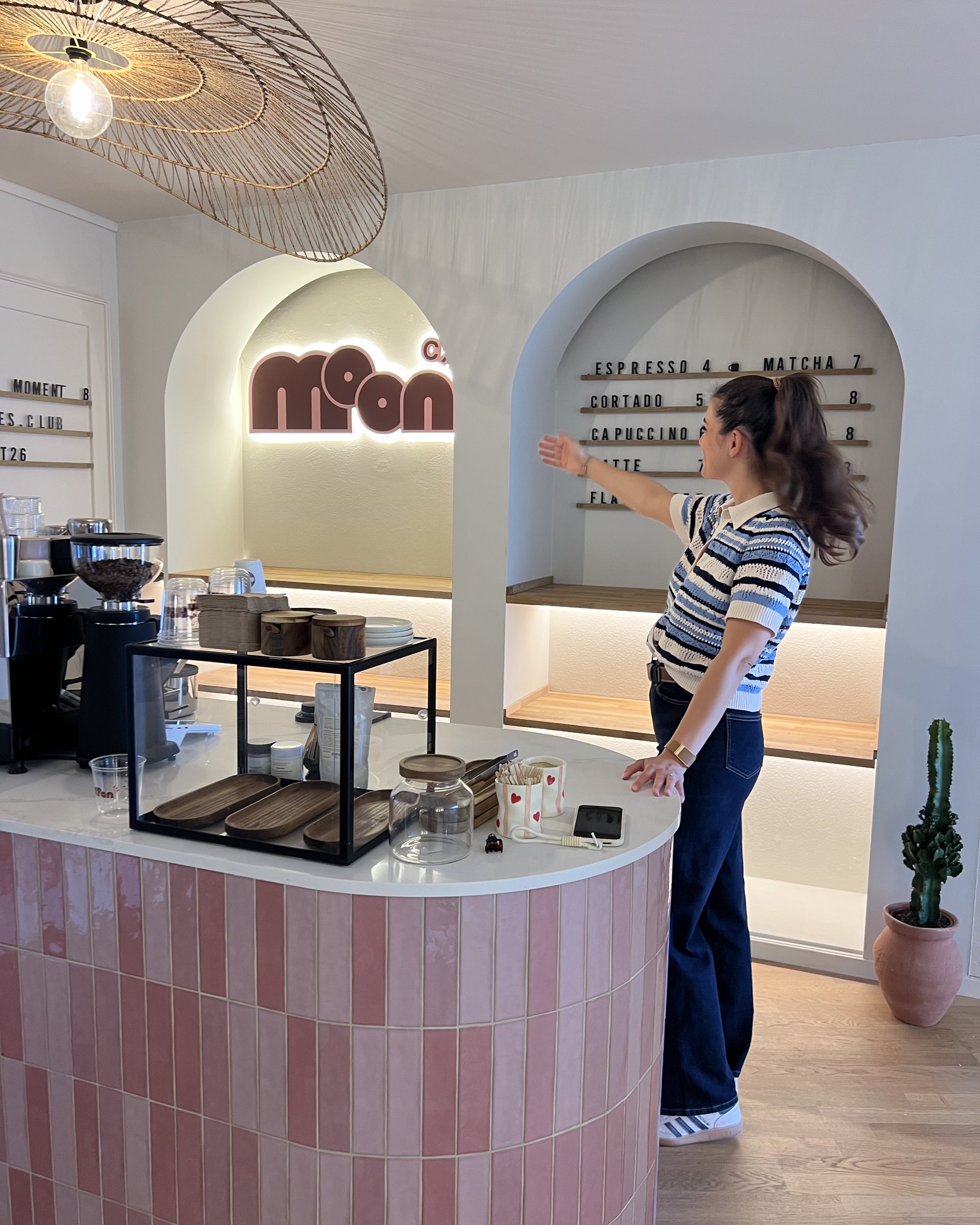 Alessia Di Dio adjusting the shelves behind the finished café bar