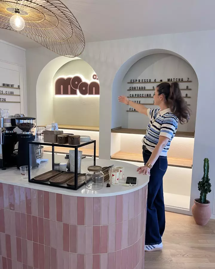 Alessia Di Dio adjusting the shelves behind the finished café bar